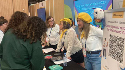 Promega employees and visitors at the 2022 iGEM booth